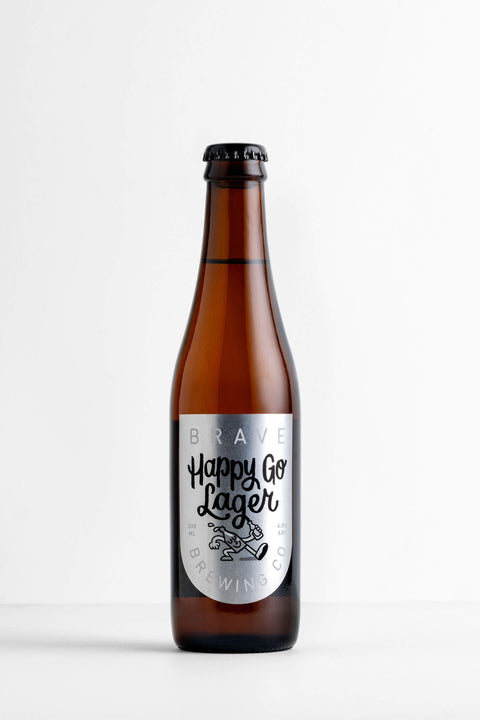 Brown bottle of 'Happy Go Lager' with a label on a white background